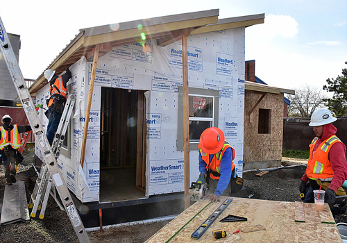 Crew is installing the weatherproofing material.